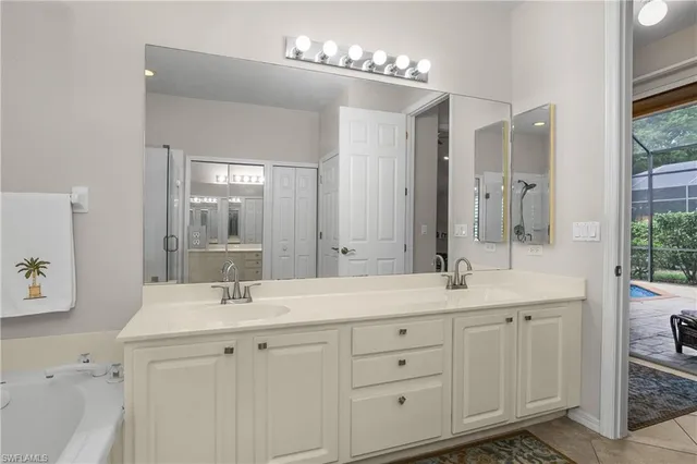 a bathroom with double sink and a mirror