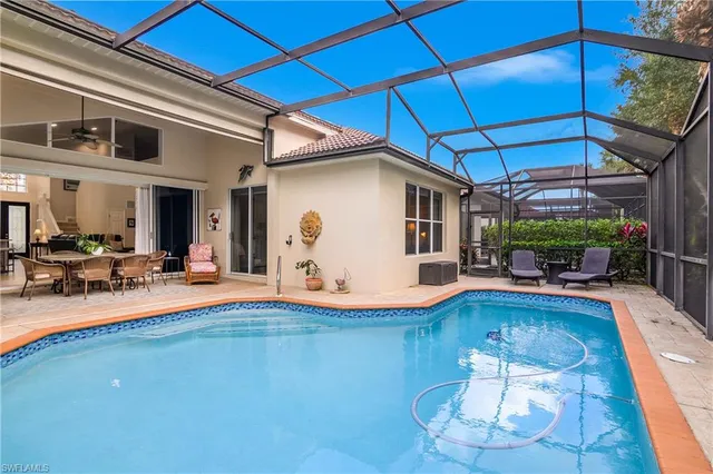 a view of swimming pool with outdoor seating