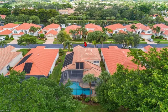 an aerial view of house with swimming pool outdoor seating and yard