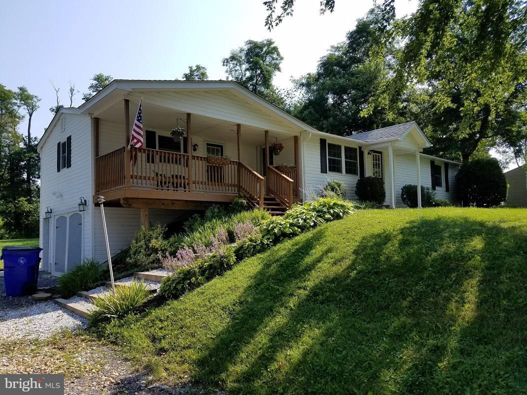 13612 Coppermine Road Union Bridge, MD 21791 - Photo 1 of 15 a front view of a house with a garden