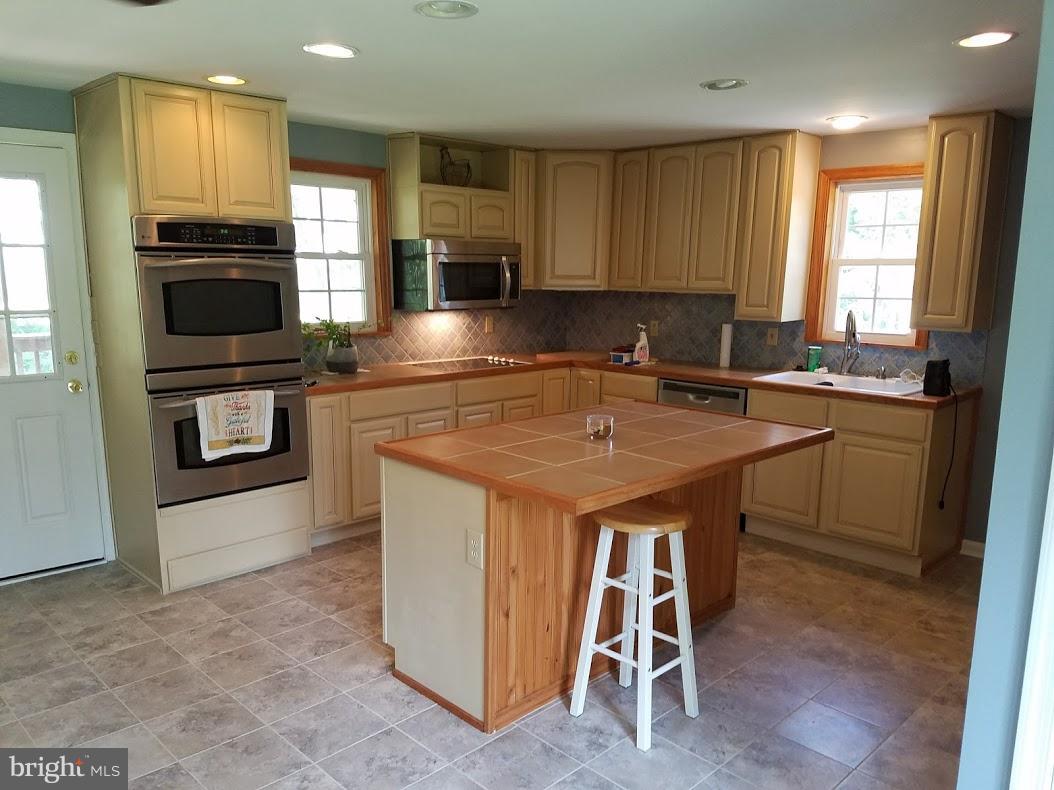 13612 Coppermine Road Union Bridge, MD 21791 - Photo 6 of 15 a kitchen with a sink appliances and cabinets