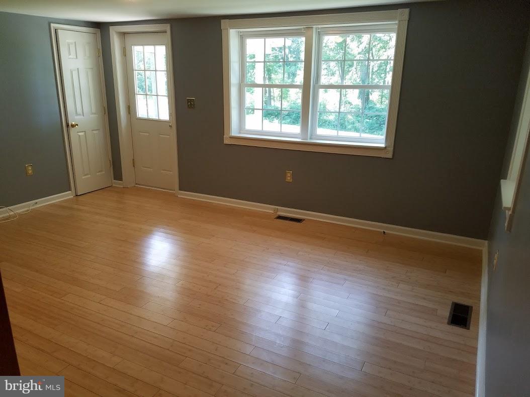 13612 Coppermine Road Union Bridge, MD 21791 - Photo 9 of 15 an empty room with wooden floor and windows