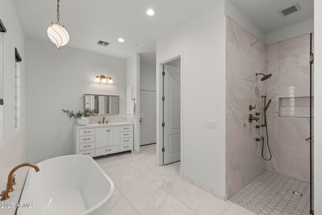 a bathroom with a bathtub sink and mirror