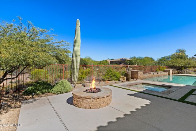 a view of a swimming pool with a lounge chair and couches in the patio