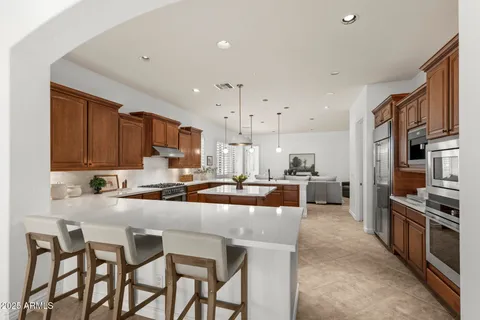 a kitchen with sink a stove and chairs