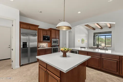 a kitchen with a sink a counter top space and stainless steel appliances