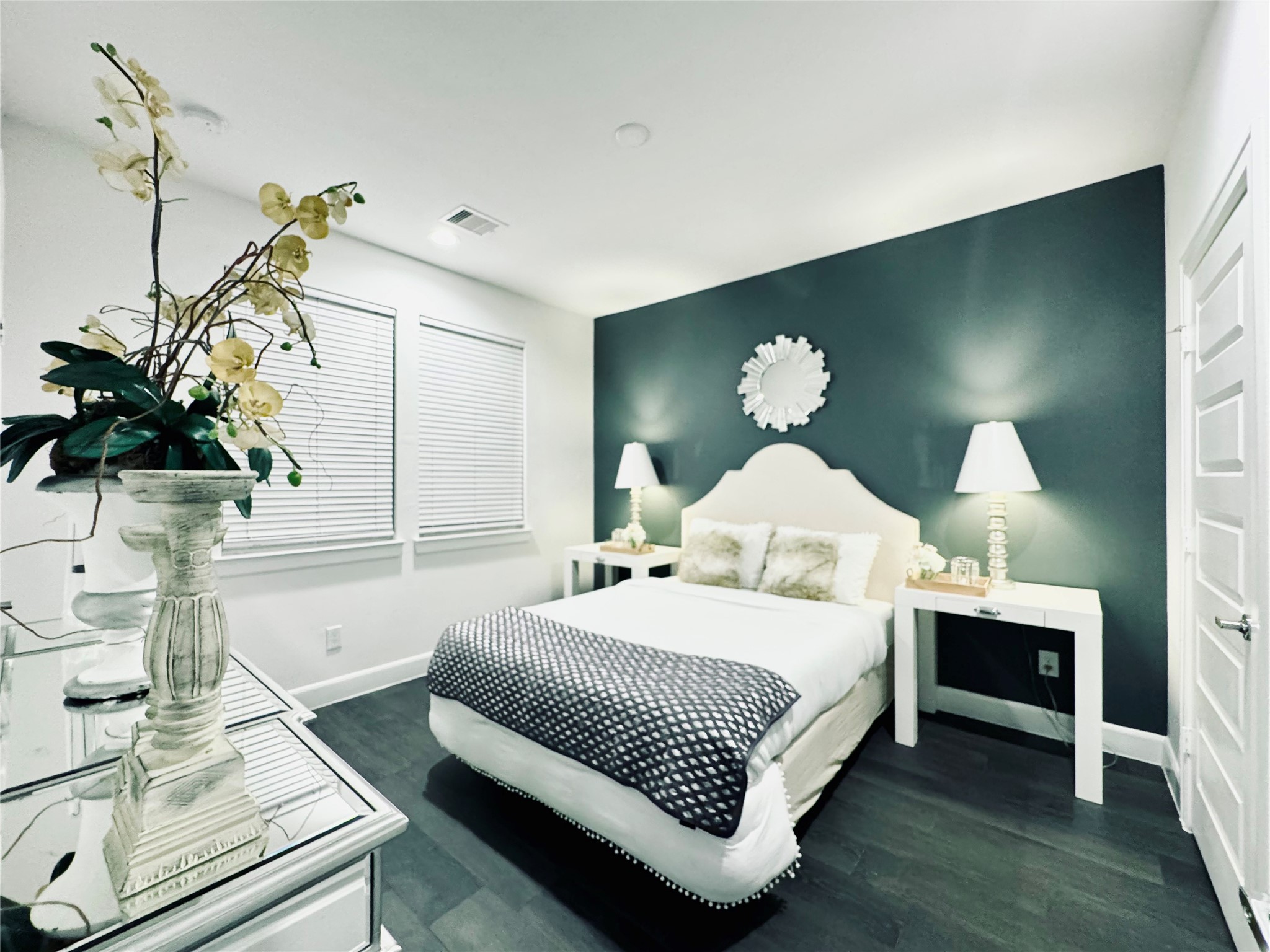 2717 Clinton Drive Houston, TX 77020 - Photo 16 of 22 a bedroom with a bed table and a potted plant