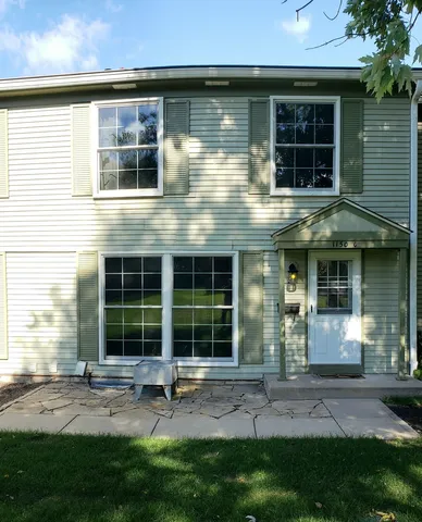 a view of a house with sitting area and garden