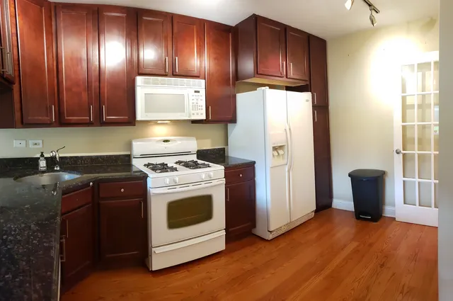 a view of kitchen with cabinets and wooden floor