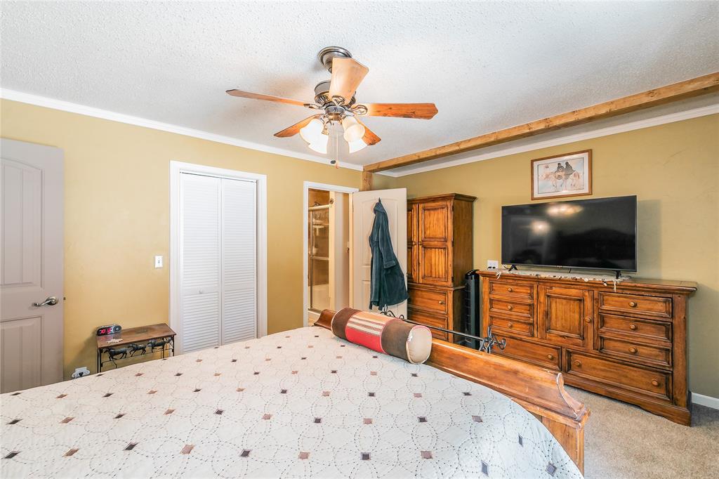 1055 Miller Road Azle, TX 76020 - Photo 17 of 40 Carpeted bedroom featuring crown molding, ceiling fan
