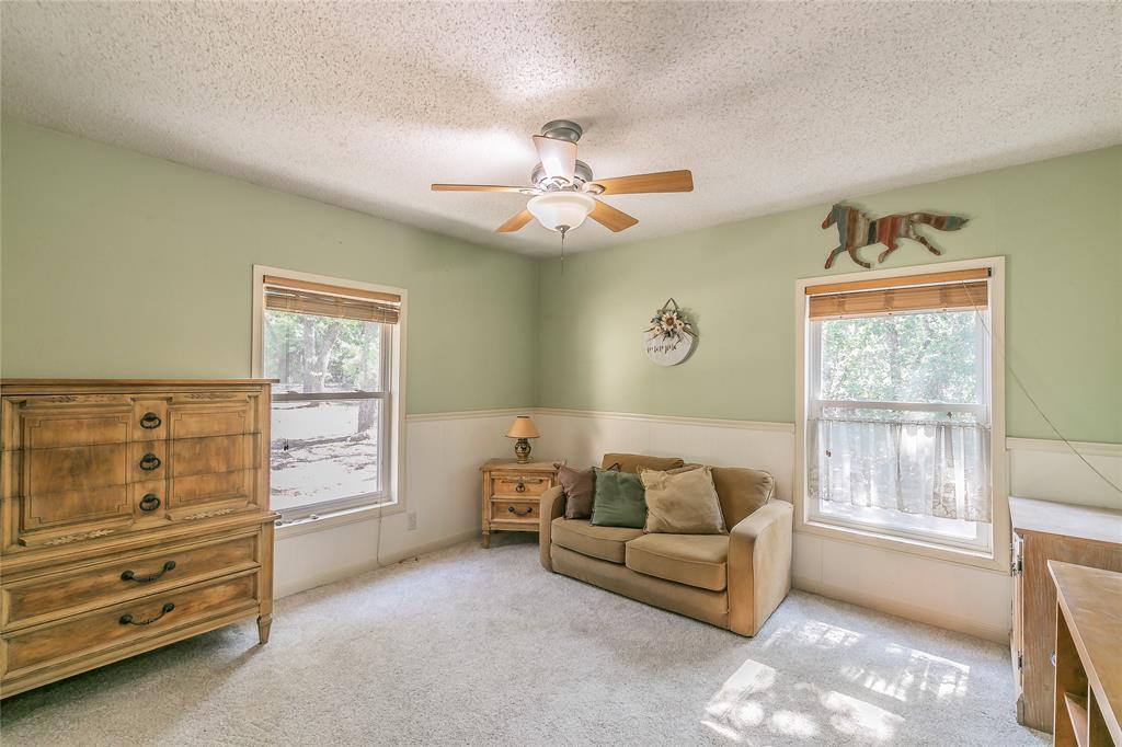 1055 Miller Road Azle, TX 76020 - Photo 24 of 40 Bedroom 3 saturated with natural light, featuring a ceiling fan, a textured ceiling, and carpet