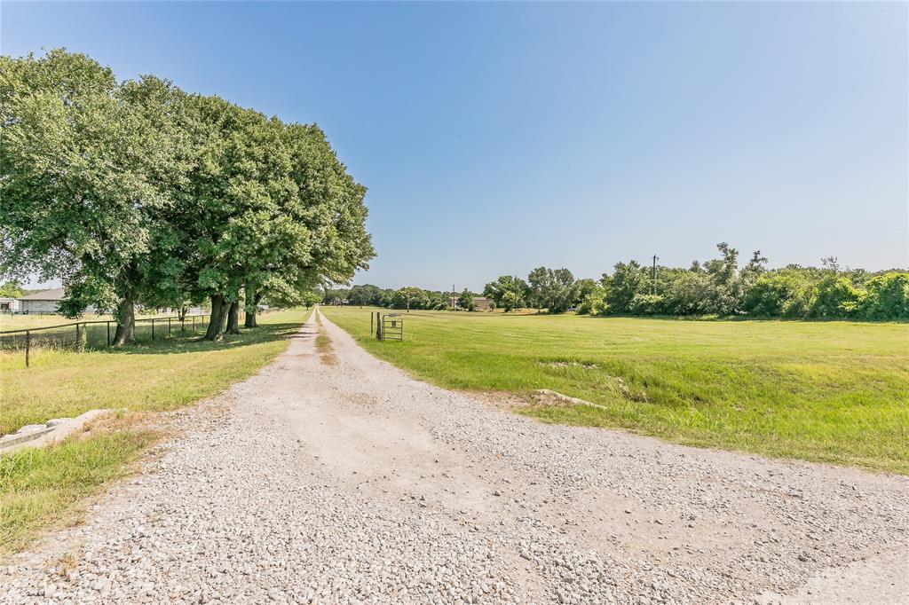 1055 Miller Road Azle, TX 76020 - Photo 32 of 40 View of gravel drive from roadfront with a view of pasture