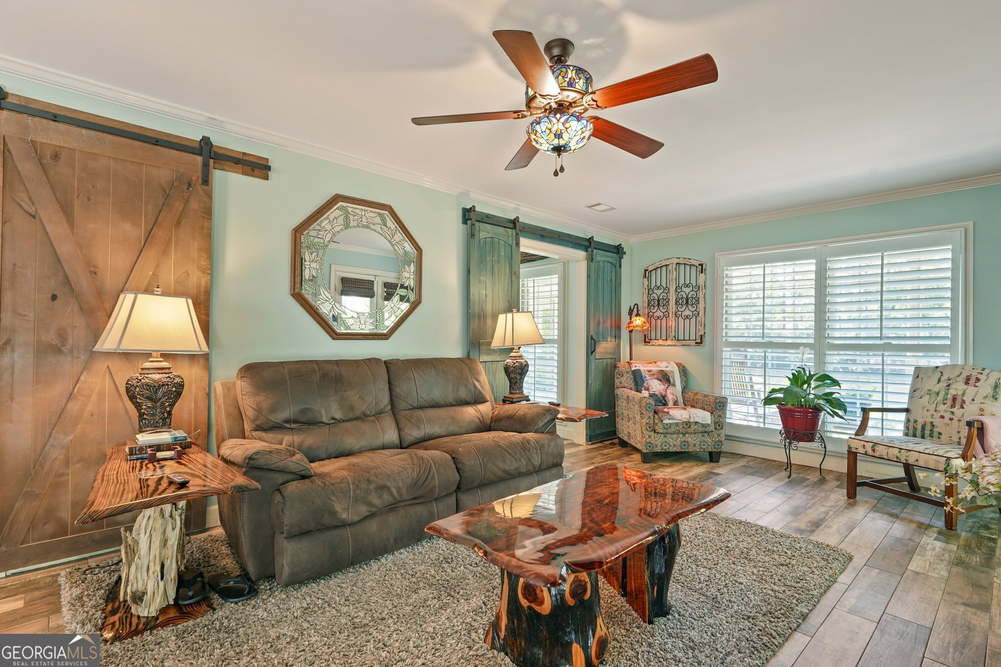600 Shore Edge Trc St. Simons Island, GA 31522 - Photo 14 of 93 a living room with furniture a clock on wall and a large window