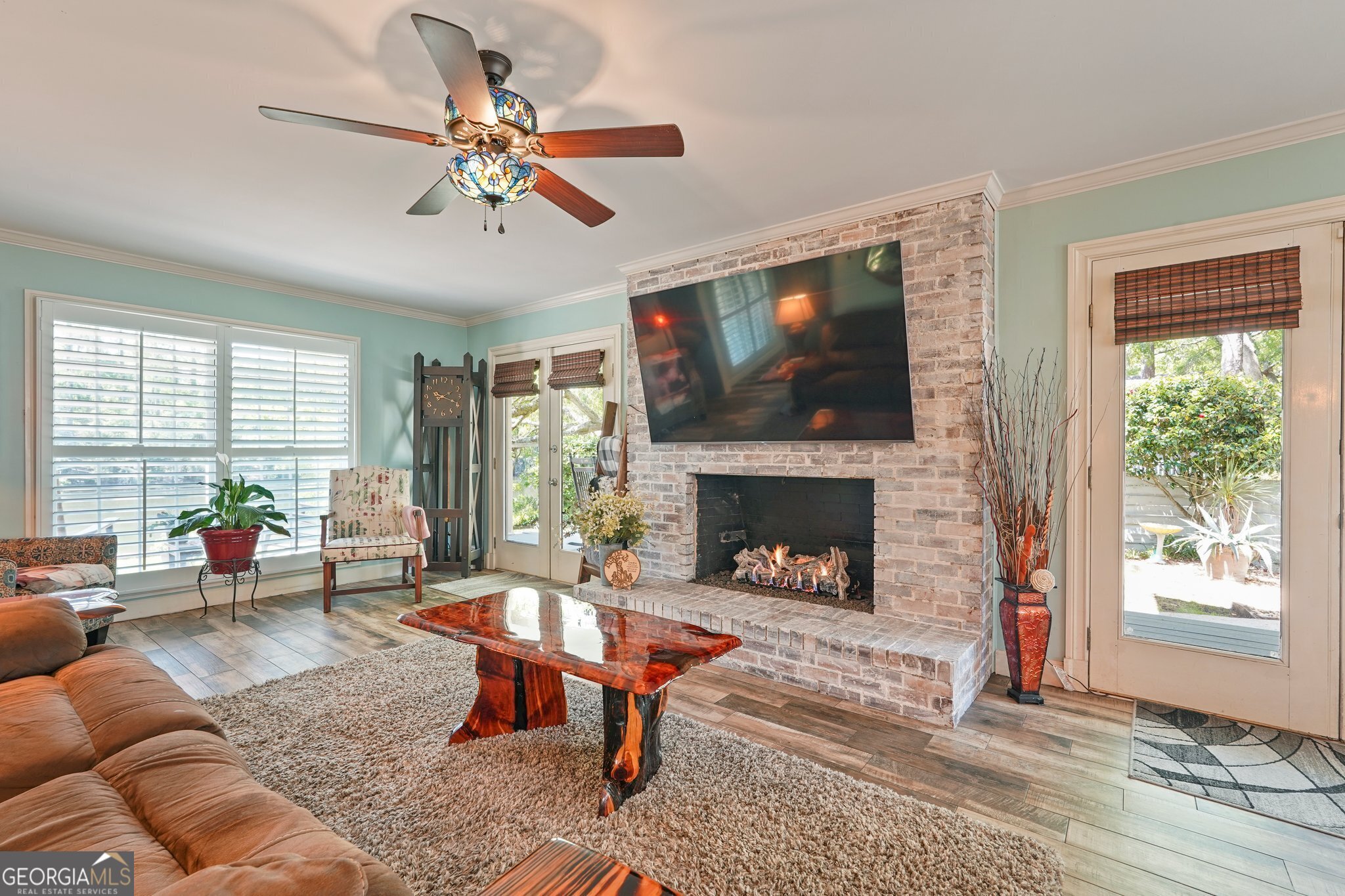 600 Shore Edge Trc St. Simons Island, GA 31522 - Photo 16 of 93 a living room with furniture a flat screen tv and a fireplace