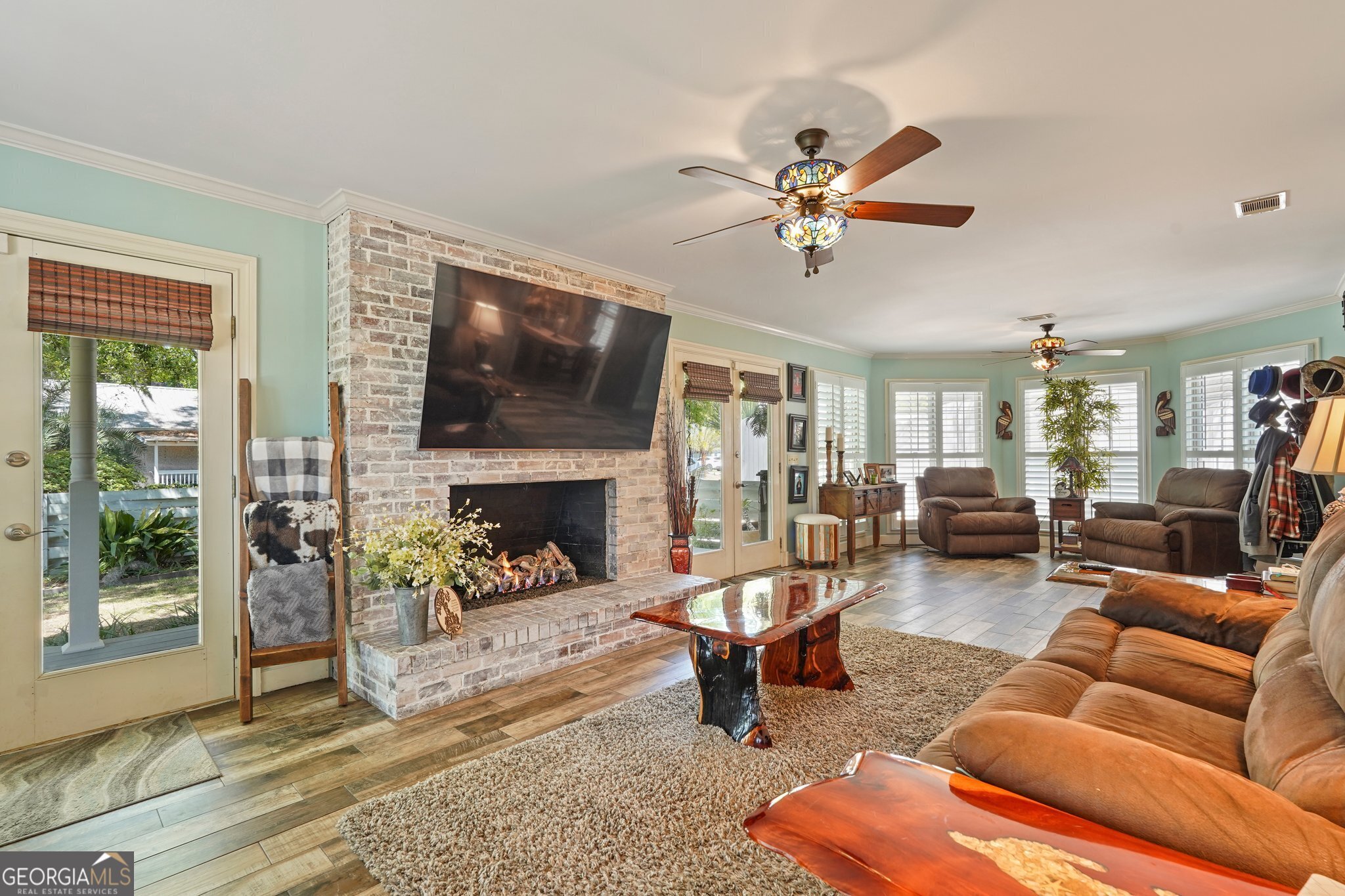 600 Shore Edge Trc St. Simons Island, GA 31522 - Photo 18 of 93 a living room with furniture a fireplace and a flat screen tv