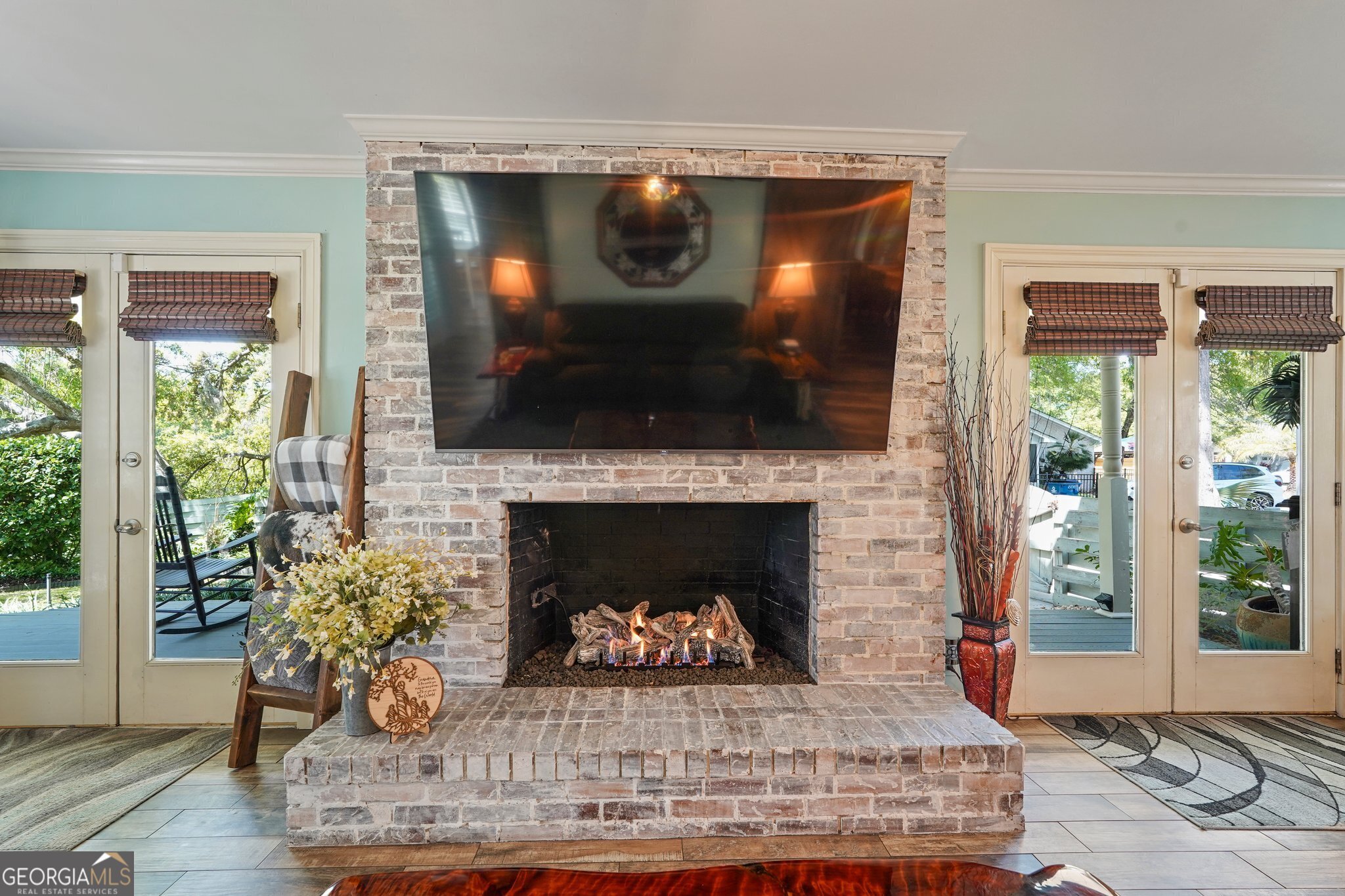 600 Shore Edge Trc St. Simons Island, GA 31522 - Photo 19 of 93 a living room with a fireplace and a flat screen tv