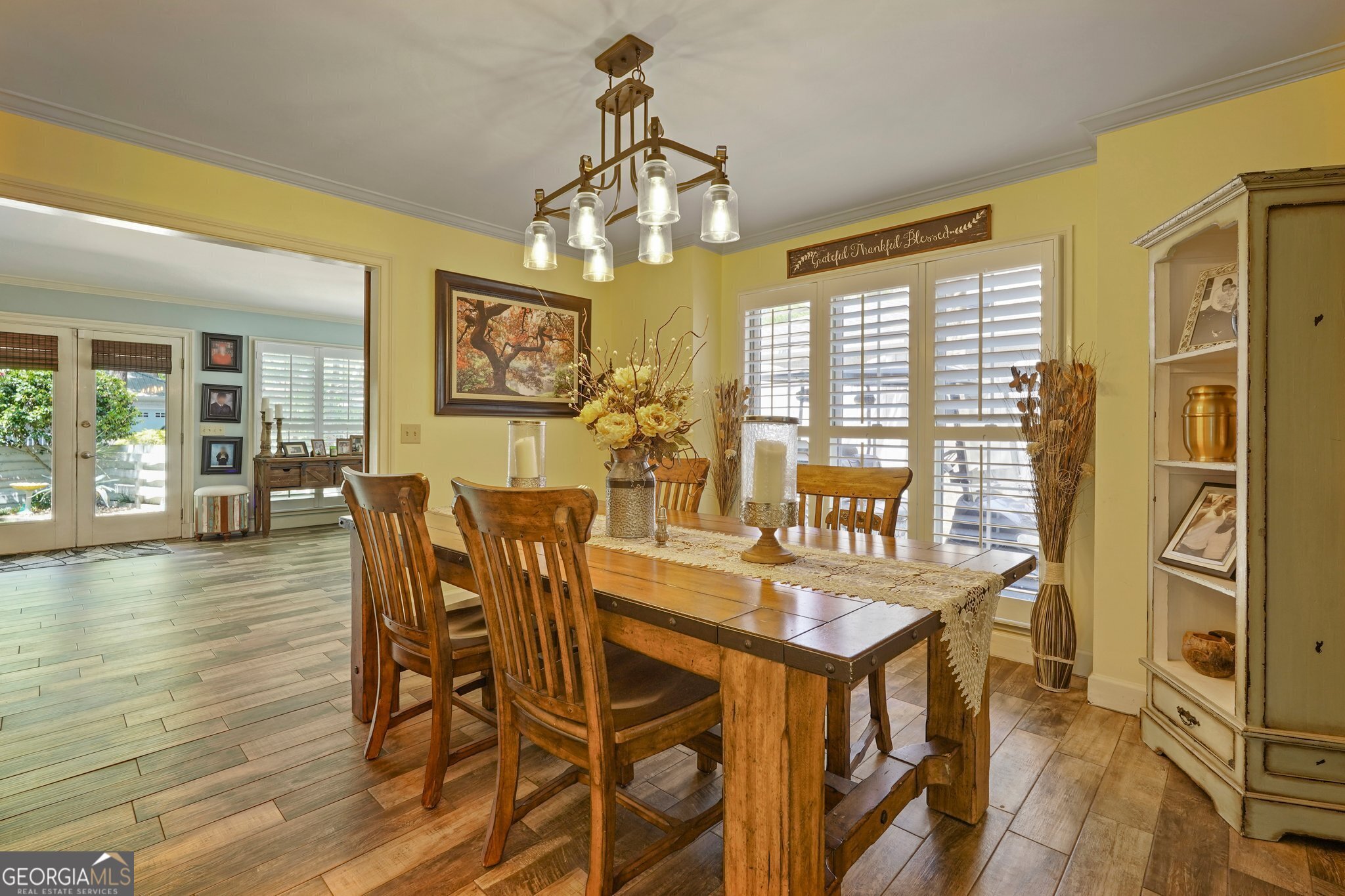 600 Shore Edge Trc St. Simons Island, GA 31522 - Photo 27 of 93 a view of a dining room with furniture wooden floor and chandelier