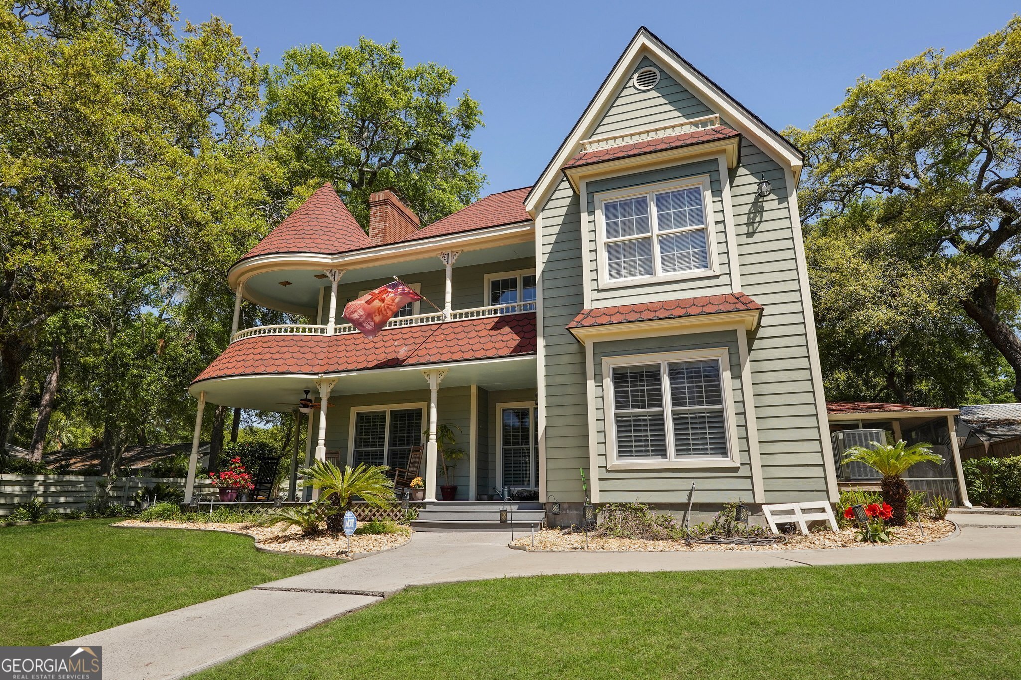 600 Shore Edge Trc St. Simons Island, GA 31522 - Photo 3 of 93 a front view of a house with garden and chairs