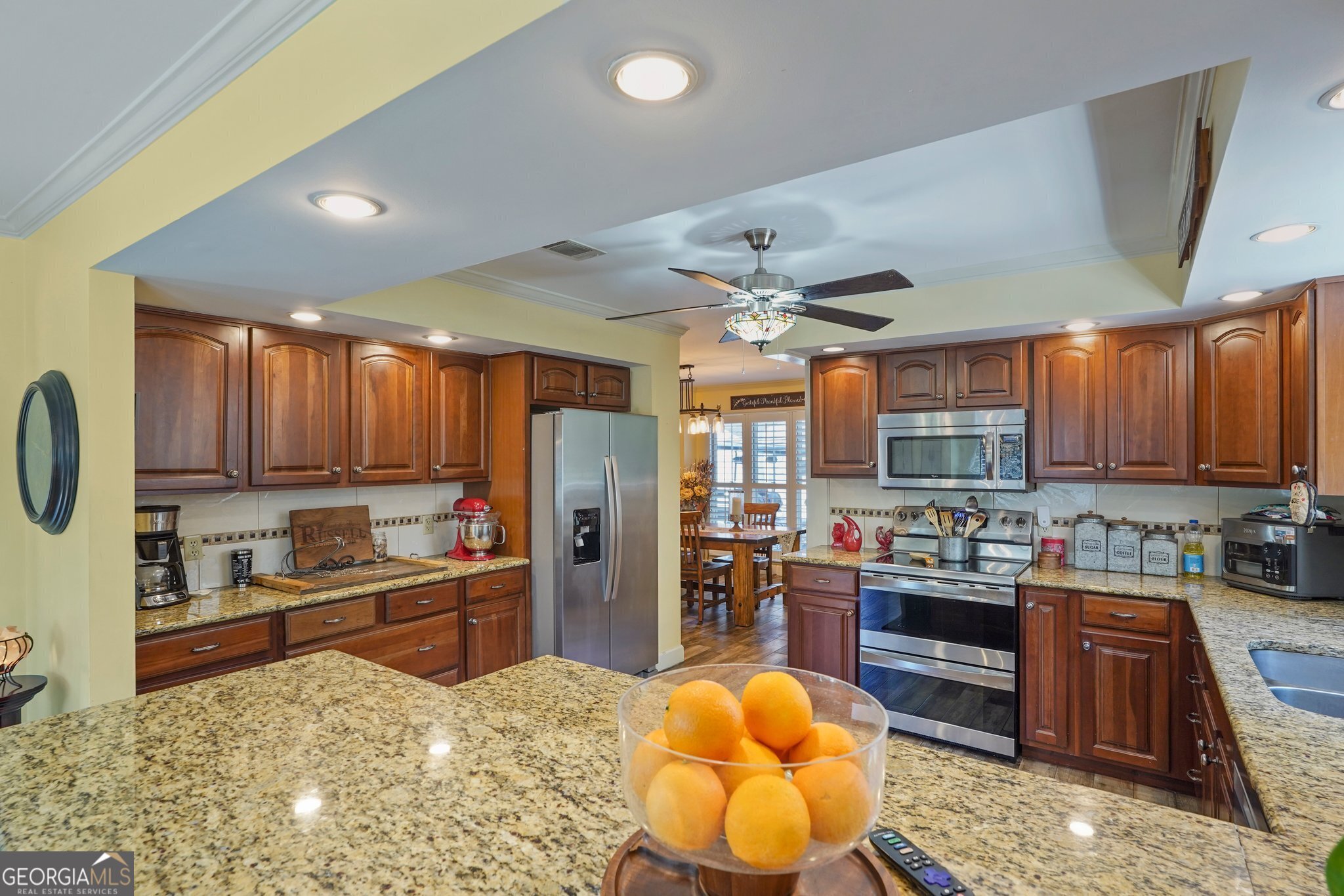600 Shore Edge Trc St. Simons Island, GA 31522 - Photo 42 of 93 a kitchen with stainless steel appliances granite countertop a stove refrigerator and cabinets