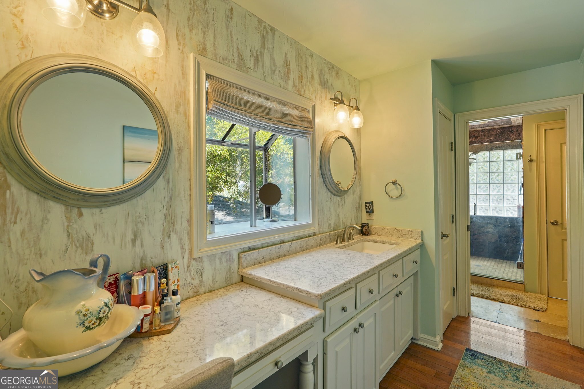 600 Shore Edge Trc St. Simons Island, GA 31522 - Photo 59 of 93 a bathroom with a granite countertop sink and a mirror