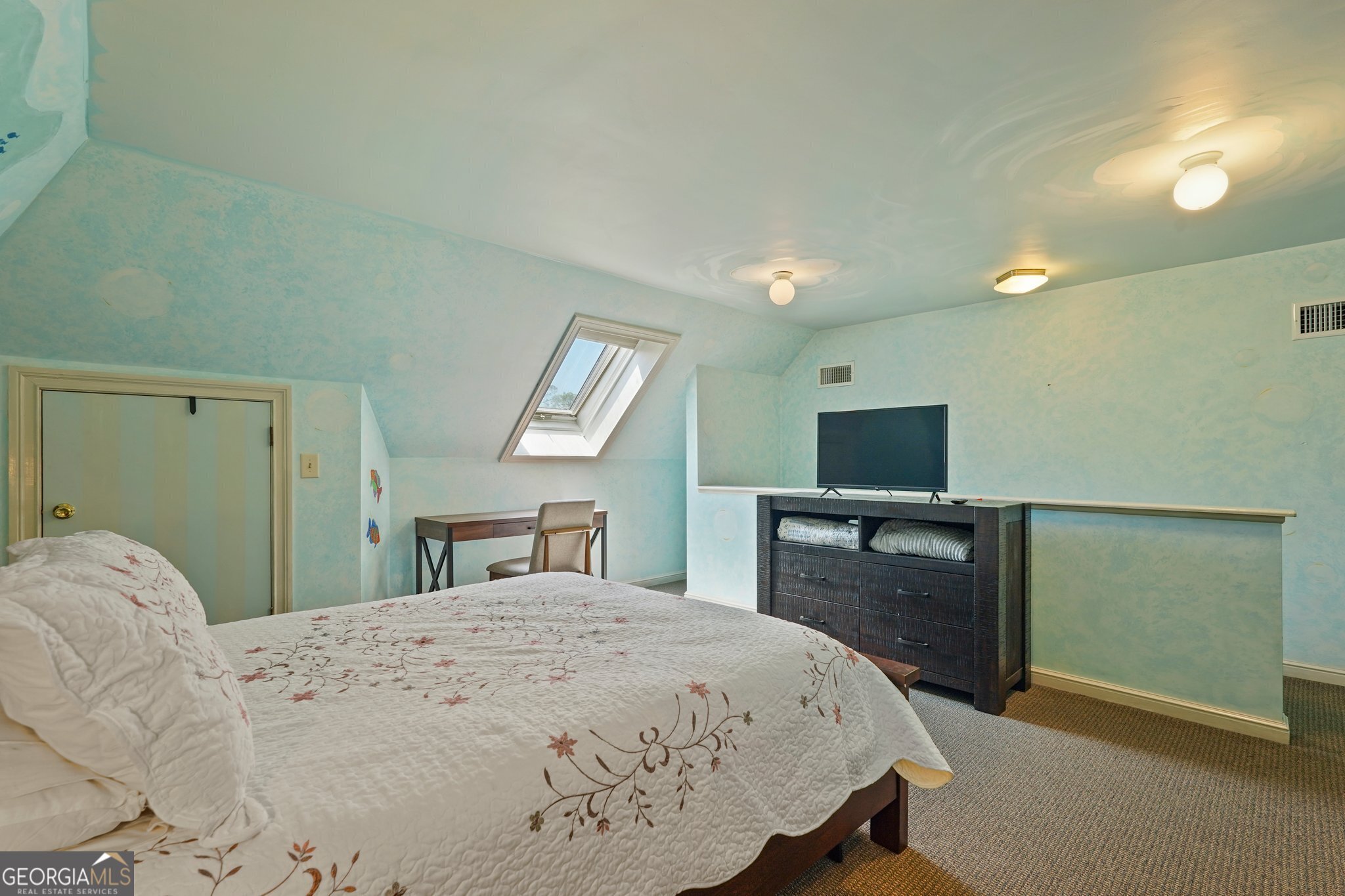 600 Shore Edge Trc St. Simons Island, GA 31522 - Photo 76 of 93 a bedroom with a large bed and a flat tv screen on dresser