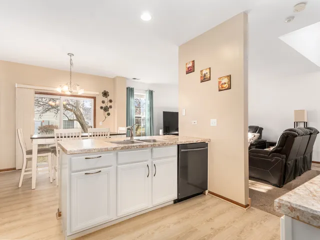 a kitchen with cabinets and chairs