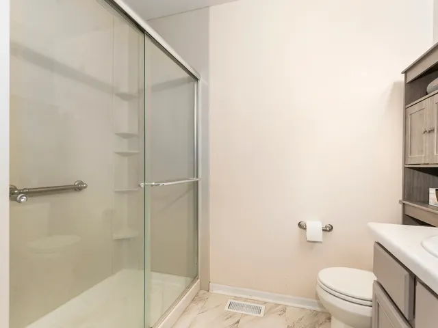 a bathroom with a shower and a toilet