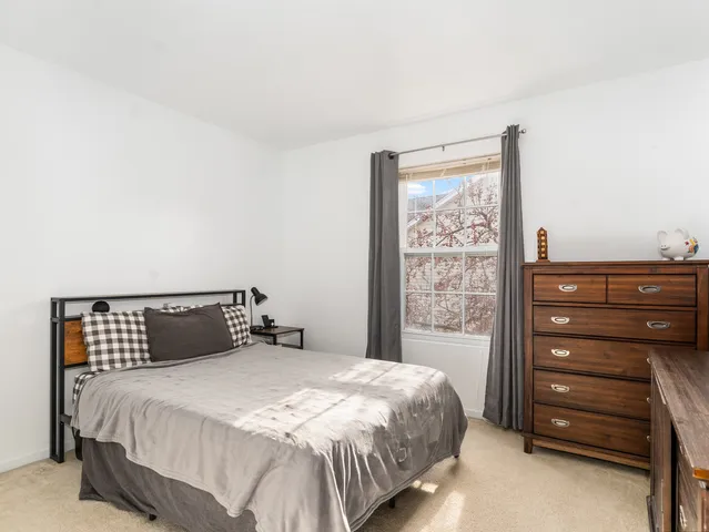 a bedroom with a bed and a dresser