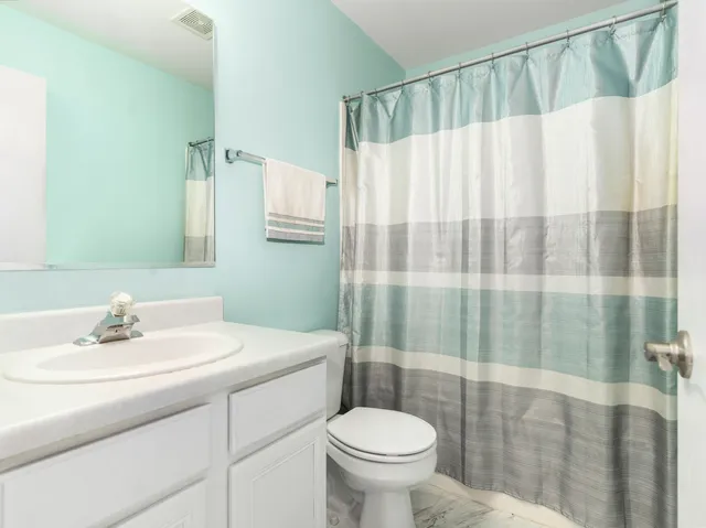 a view of a house with backyard and a tree