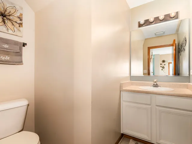 a bathroom with a toilet a sink and mirror