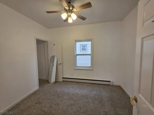 an empty room with a view of a house