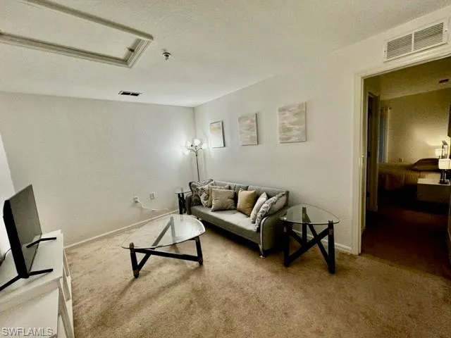 a living room with furniture and a rug