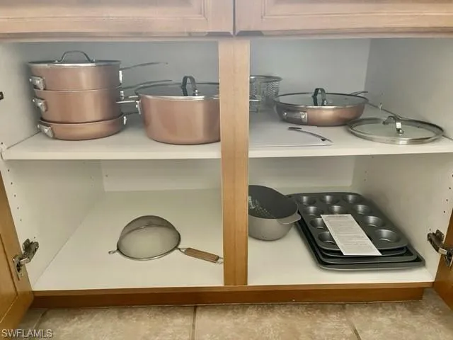 a shelf with wooden floor and cabinets