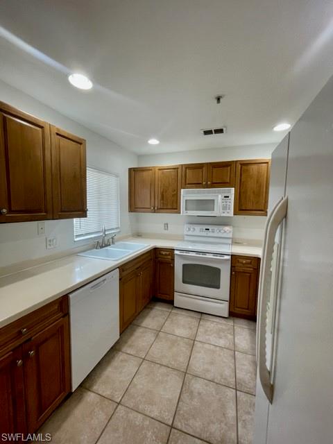 9430 Ivy Brook Run, Unit 403 Fort Myers, FL 33913 - Photo 5 of 25 a kitchen with stainless steel appliances granite countertop a stove a sink and a refrigerator