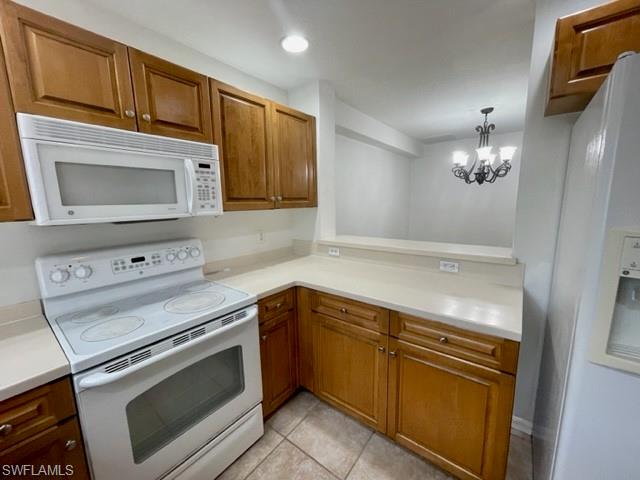 9430 Ivy Brook Run, Unit 403 Fort Myers, FL 33913 - Photo 7 of 25 a kitchen with granite countertop cabinets stainless steel appliances and a stove top oven