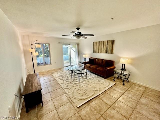 9430 Ivy Brook Run, Unit 403 Fort Myers, FL 33913 - Photo 9 of 25 a living room with furniture and a chandelier