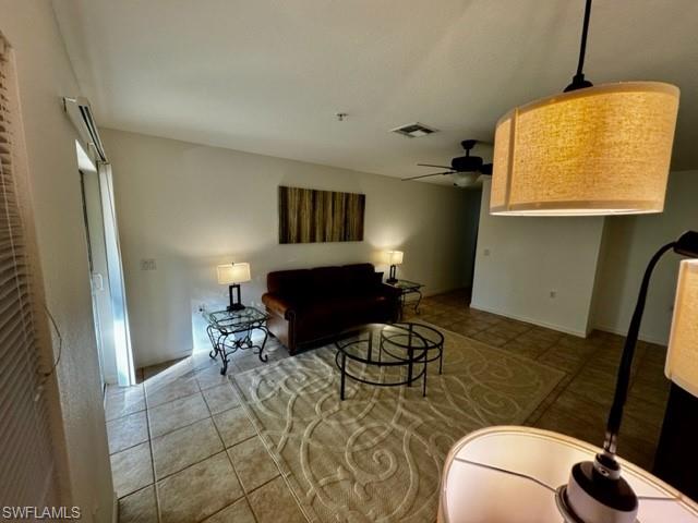 9430 Ivy Brook Run, Unit 403 Fort Myers, FL 33913 - Photo 10 of 25 a living room with furniture and a flat screen tv