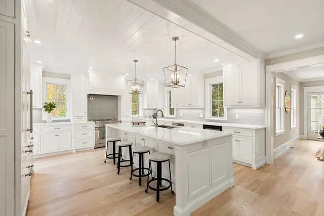 a kitchen with a sink a counter top space appliances and cabinets
