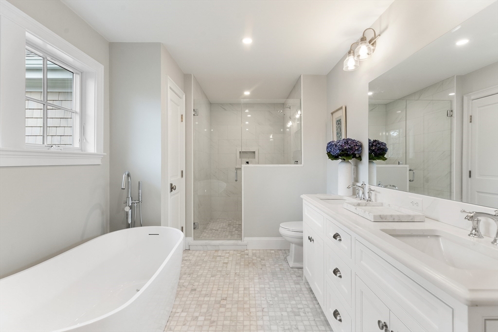 6 Revolutionary Road Lexington, MA 02421 - Photo 14 of 23 a bathroom with a tub sink and mirror