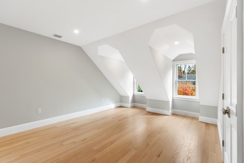 6 Revolutionary Road Lexington, MA 02421 - Photo 16 of 23 an empty room with wooden floor and windows