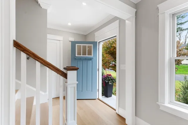 a large white kitchen has white cabinets and stainless steel appliances