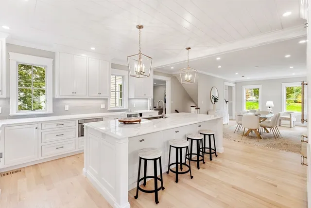 a dining room with wooden floor and a rug
