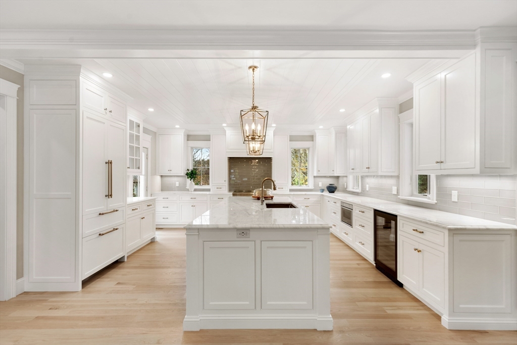 6 Revolutionary Road Lexington, MA 02421 - Photo 5 of 23 a large white kitchen has white cabinets and stainless steel appliances