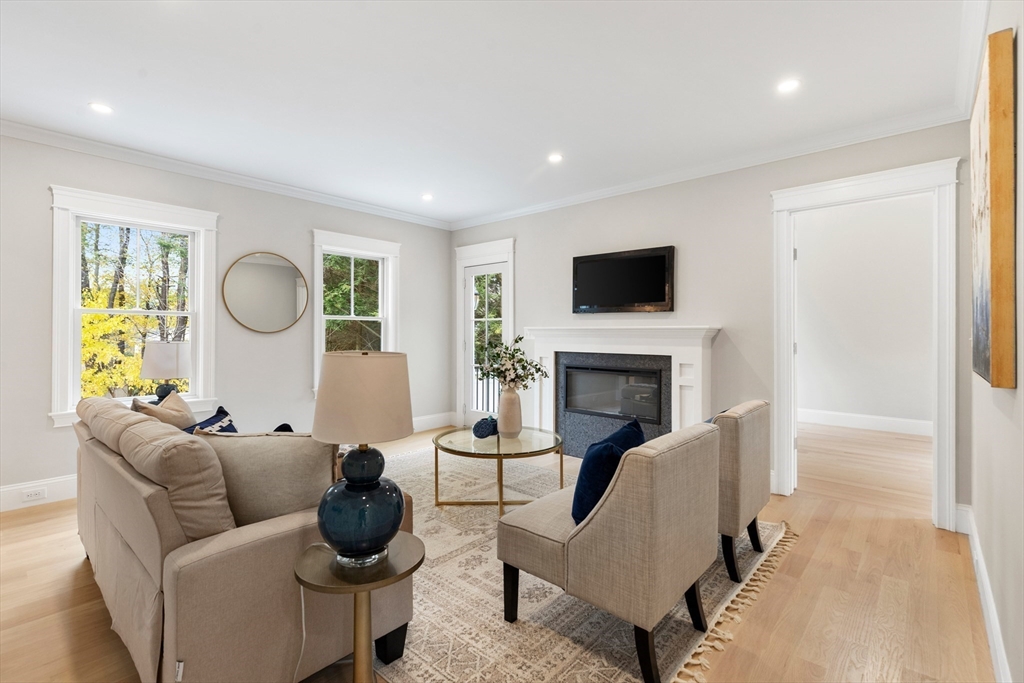 6 Revolutionary Road Lexington, MA 02421 - Photo 7 of 23 a living room with furniture a fireplace and a flat screen tv