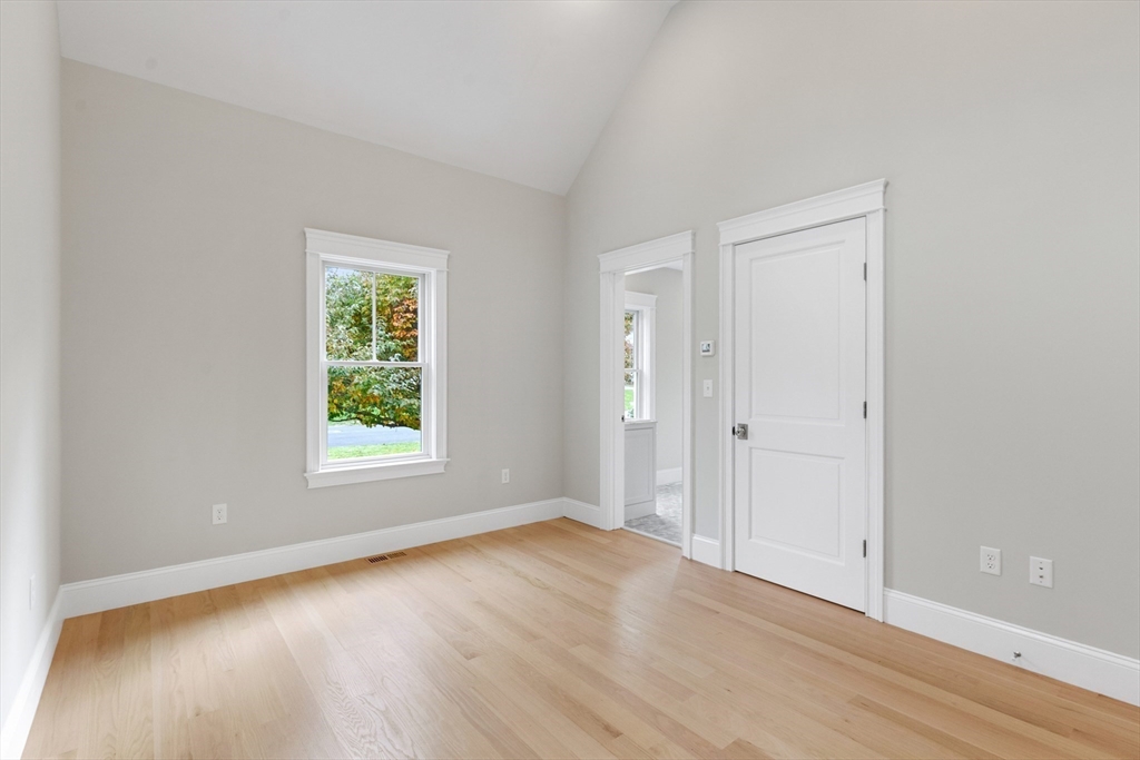 6 Revolutionary Road Lexington, MA 02421 - Photo 9 of 23 an empty room with wooden floor and window