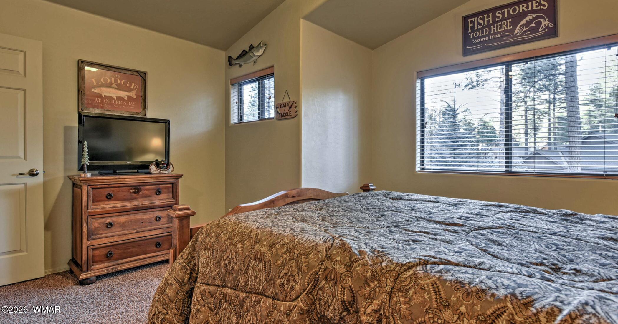 2942 Timber Line Road Pinetop, AZ 85935 - Photo 18 of 27 a bedroom with a bed and a flat screen tv