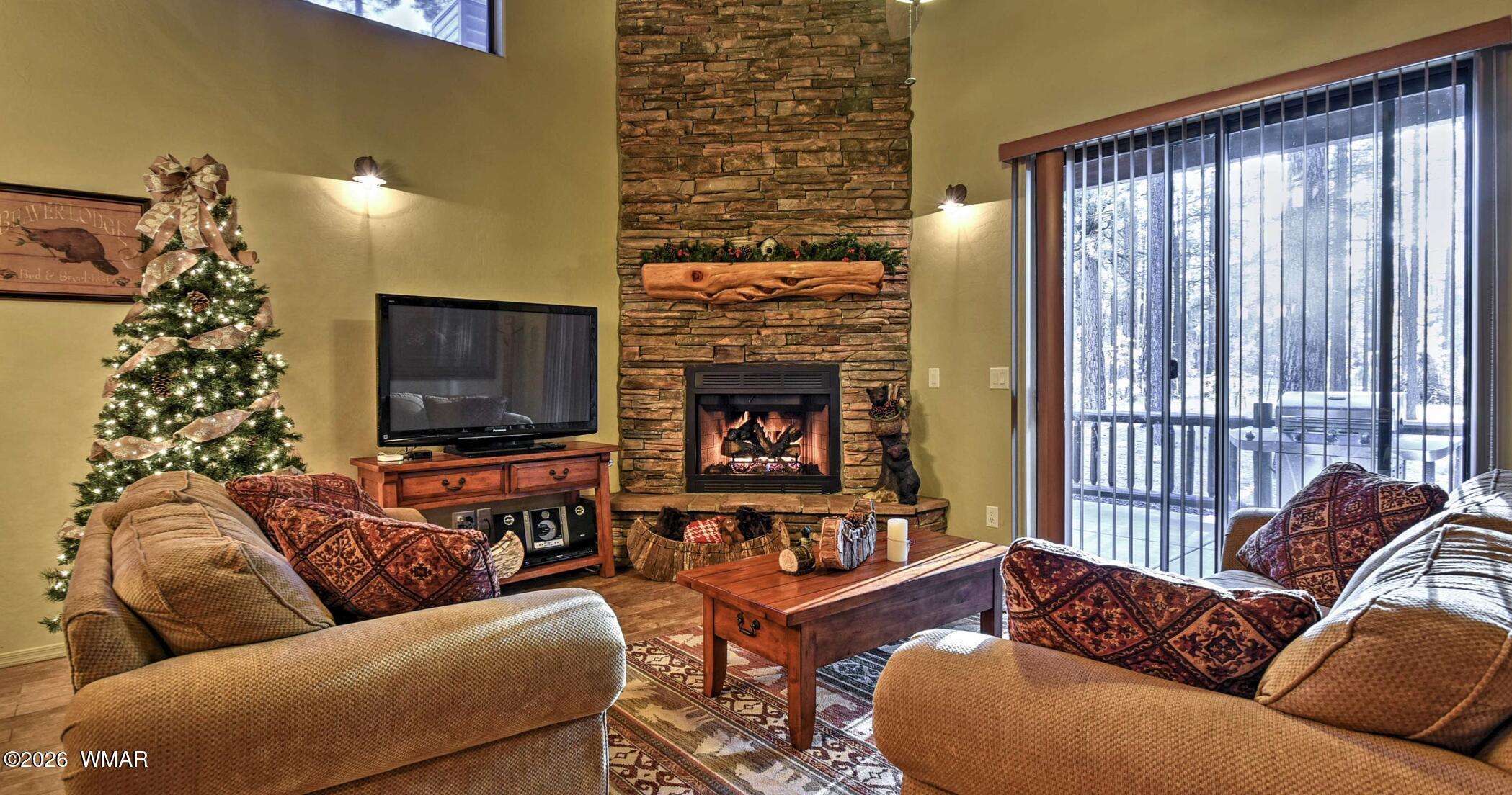 2942 Timber Line Road Pinetop, AZ 85935 - Photo 4 of 27 a living room with furniture window and a fireplace