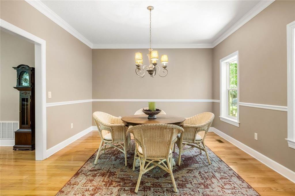 704 Riverbend Road Blairsville, GA 30512 - Photo 39 of 89 a view of a dining room with furniture a chandelier and wooden floor