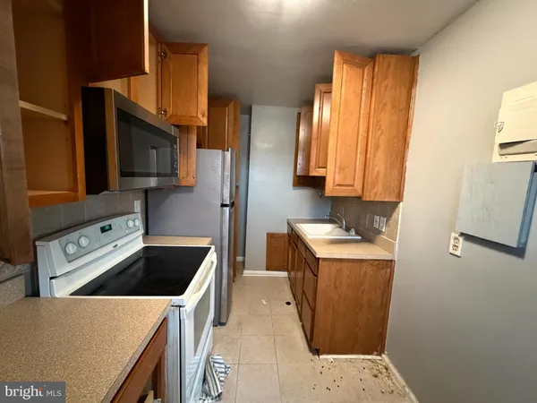 a kitchen with a sink a stove and a refrigerator