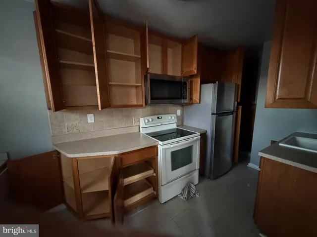 a kitchen with stainless steel appliances a stove a microwave and a refrigerator